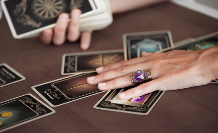 woman resting her hands on a tarot spread